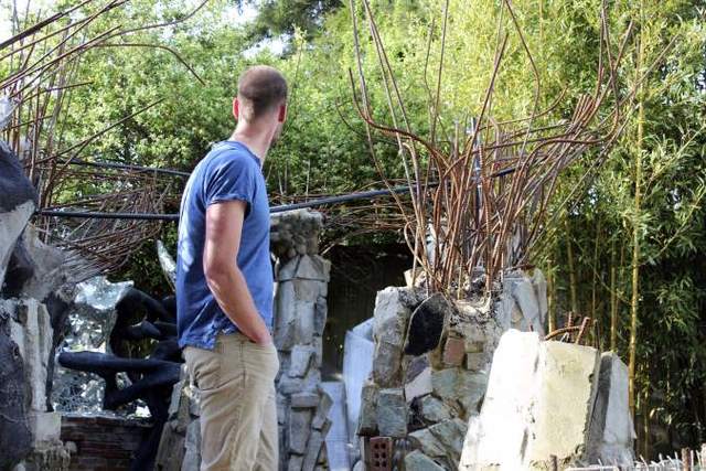 Michael Henderson during the demolition of his Undersea Aviary. Photo by Sara Bernard