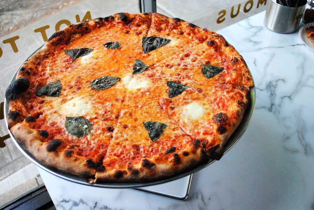 Mozzarella, basil and parmesan pizza from Dino's Tomato Pie. By Lindsey Yamada