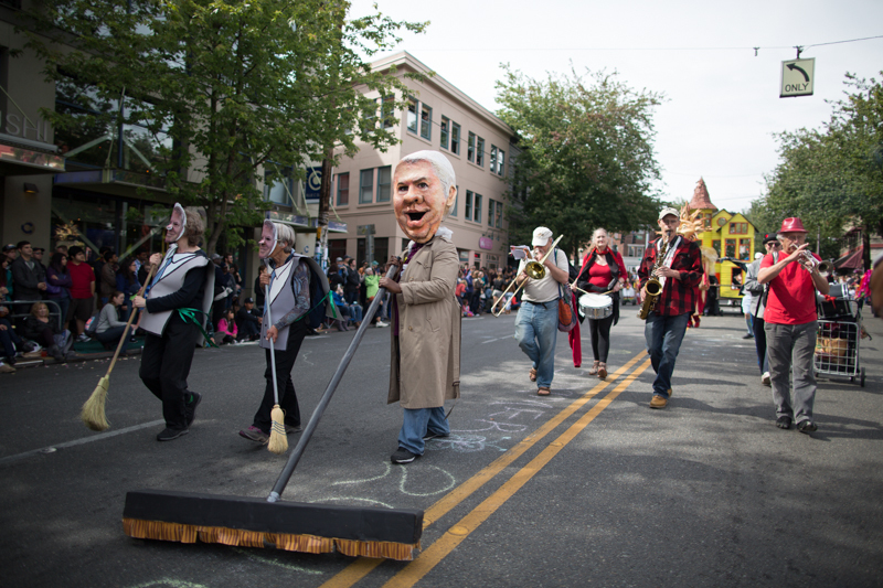 Dressed as Mayor Ed Murray, a group pretends to sweep homeless out of the city.
