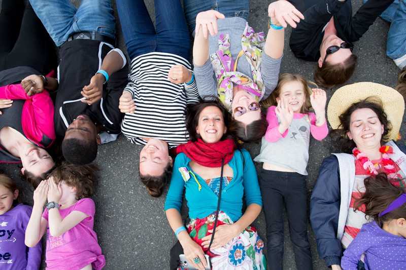 Onlookers turn into participants as they await a giant inflatable ball to run over them.