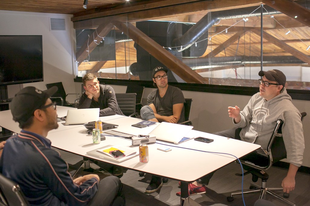 Chris Chan talks with Cut co-founders Blaine Ludy, Jason Hakala, and Mike Gaston at the Cut offices. Photo by Nathaniel Solis