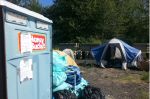 Toilet and tents at Camp Second Chance. Photo by Casey Jaywork.