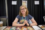 &ldquo;I think we need to address language. As a female, bisexual, religious gamer, the language that is used for a lot of things promotes harassment. If it becomes OK to use pejorative words to describe people that means it&rsquo;s not ok to be that person. Another is visual representation. In Magic, I&rsquo;m really grateful for the artists and designers for making choices regarding having female characters shown on Magic cards, fully dressed. Being shown as powerful and capable as opposed to earlier on there was a tendency to be either young and sexy or the old crone who is somewhat despicable and frightening. Quite recently there was a new Magic card, Arlinn Kord, who is a very powerful, middle aged woman who is the leader of her people. She is fully dressed, all of her representation shows a middle aged woman who is very attractive and very confident. That is great. In the visual representation and the language being used, including more options, more people being shown, creates a safer space for other people coming in and see themselves in the art and not be insulted by the language helps to create these kinds of environments.&rdquo; -Emily Jarrett