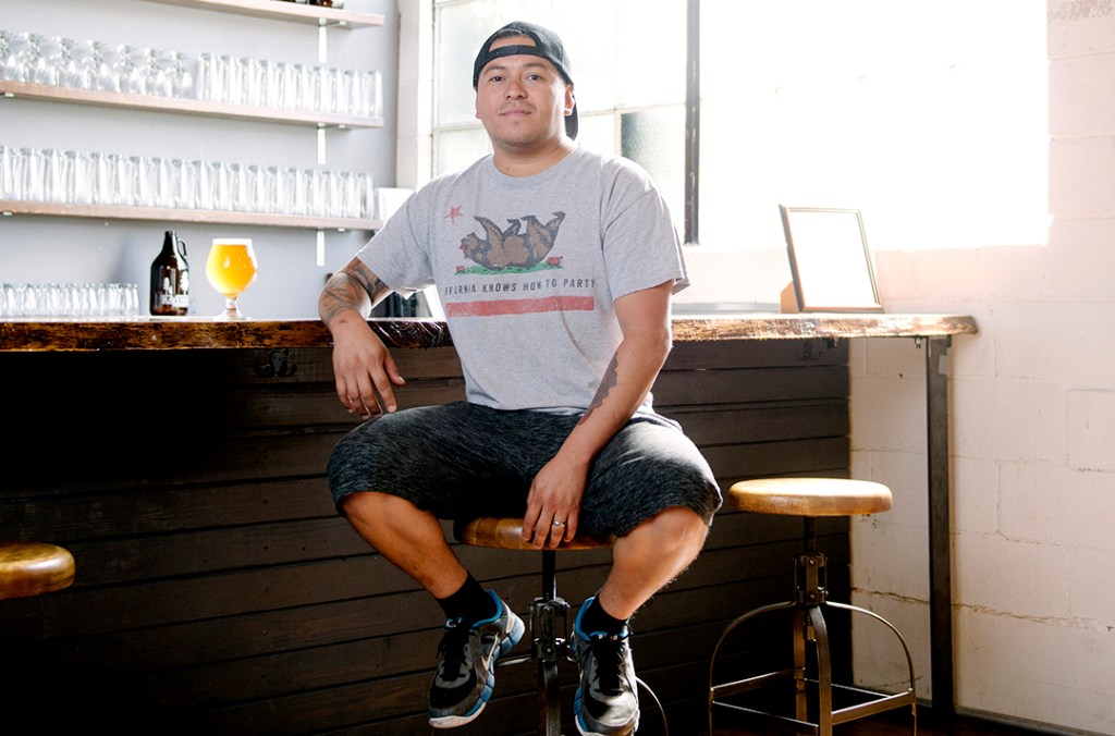 Ravenna Brewing Owner Tommy Ortega is focused on craft-brewing flavorful specialty beers. Originally from Hermosa Beach, California, Ortega framed a letter from a longtime customer who would come in almost daily and wrote to say not to worry in his absence. Photo by Daniel Berman