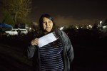 Talia Antone, holding court papers from her arrest at the protest site in North Dakota. Photo by Alex Garland