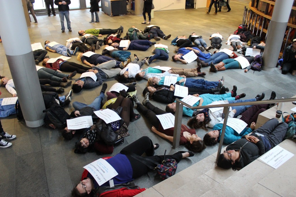 Nurses and health professionals stage a die-in at City Hall in support of establishing safe drug sites in Seattle. Photo by Casey Jaywork.