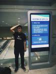 Allen Huang wearing his booking collective Customs&rsquo; shirt at airport customs. Courtesy of the artist