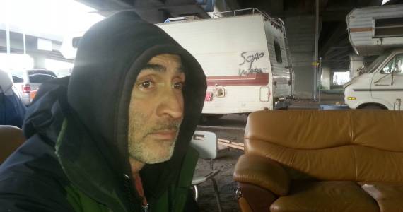 RV camper Tsiago Cross, the evening before he expects to be evicted from Trollsville below the West Seattle bridge. Photo by Casey Jaywork.