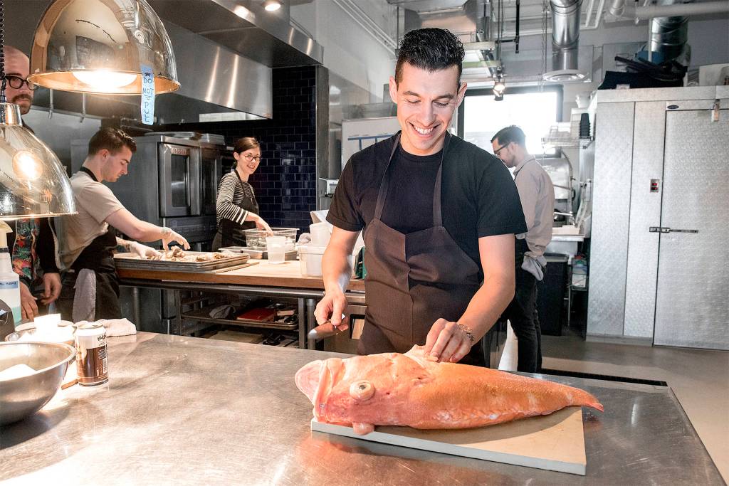 JJ Proville filets a rock fish. Photo by Morgen Schuler