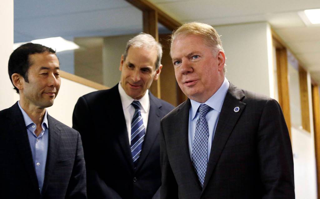 Mayor Murray walks past his husband, Michael Shiosaki, left, and his attorney, Bob Sulkin, before speaking to the media on Friday, April 7, 2017, in Seattle. AP Photo/Elaine Thompson