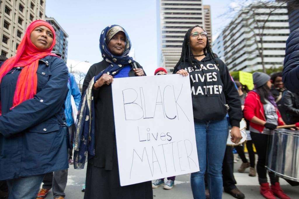 Kamara Blackwell, right, and Hamdi Abdulle march. &ldquo;As president he should be able to release public information to all citizens of America, and I think that it&rsquo;s totally fair that we demand that of him,&rdquo; Blackwell said.