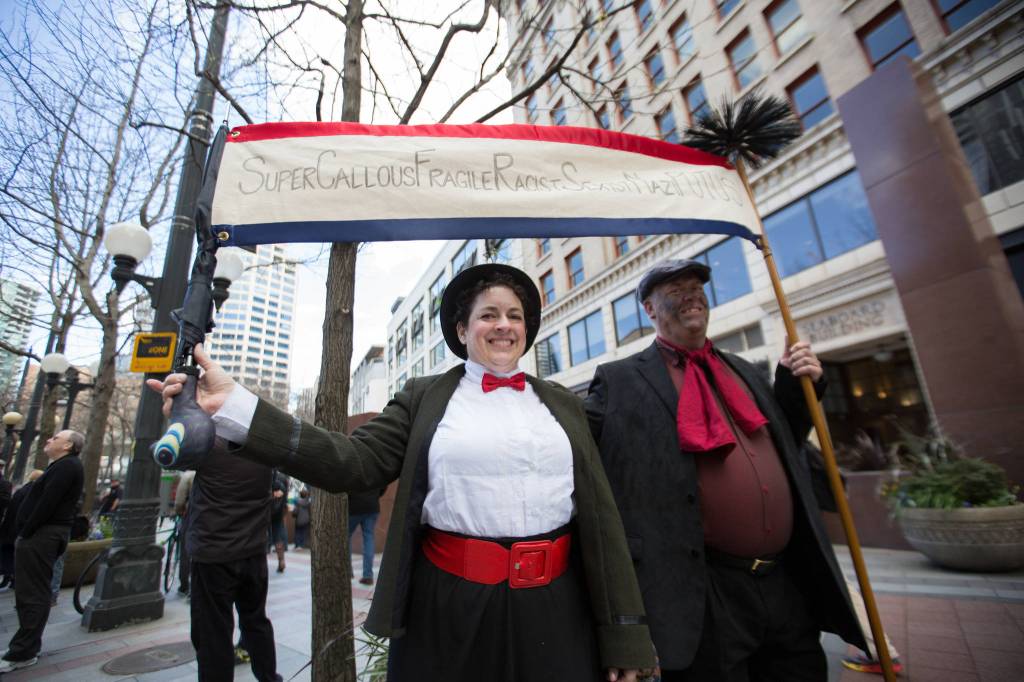 Bree Fish, left and John Kohlsaat came from Everett to protest. &ldquo;We want to let people know that we care and that we&rsquo;re aware and we will continue to resist and fight,&rdquo; John said.