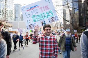 Rami Atallah of Shoreline marches in Seattle&rsquo;s Tax Day Protest earlier this year. Photo by Alex Garland