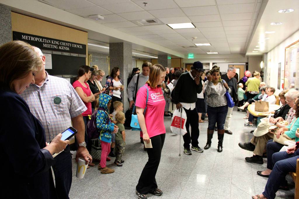 Attendees wait outside the King County Council Chambers at the Board of Health hearing on July 20. Photo by Sara Bernard