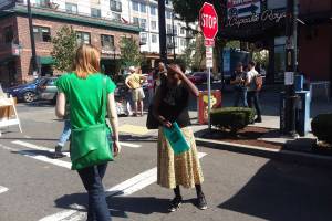 District 7 NACtivist Shaun Glaze petitions a farmers market shopper for her signature. Photo by Casey Jaywork