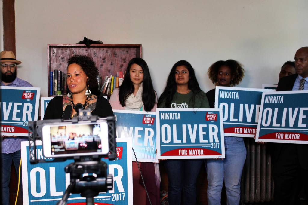 Nikkita Oliver backed by members of the Seattle Peoples Party at Washington Hall on August 15. Photo by Sara Bernard