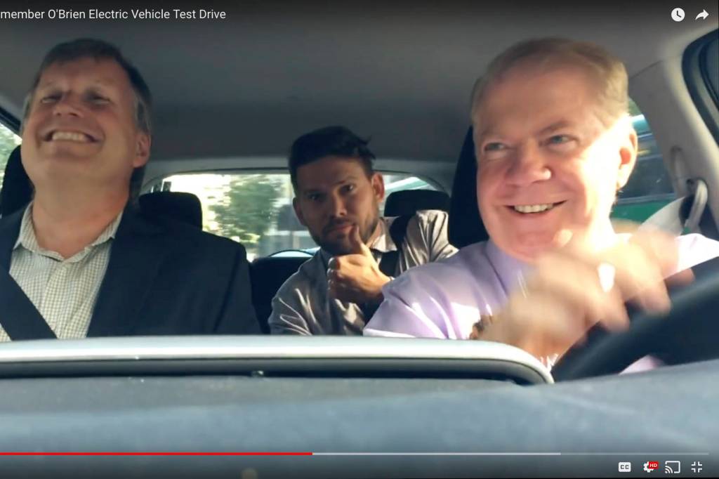 Left to right: Seattle City Councilmember Mike O&rsquo;Brien, mayoral staffer Will Lemke, and Mayor Ed Murray &lsquo;test-drive&rsquo; an electric car in September 2016. Screenshot via Seattle City Council