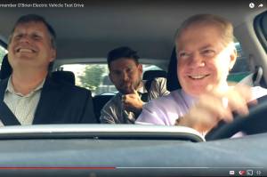 Left to right: Seattle City Councilmember Mike O&rsquo;Brien, mayoral staffer Will Lemke, and Mayor Ed Murray &lsquo;test-drive&rsquo; an electric car in September 2016. Screenshot via Seattle City Council