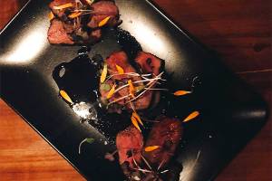 Bison strip loin with charred onion jus. Courtesy of Carnivore