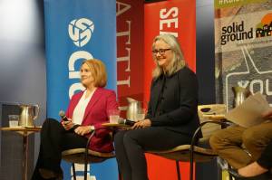 Jenny Durkan (left) and Cary Moon on stage inside Seattle University&rsquo;s Pigott Auditorium at the Solid Ground debate on housing and homelessness on Tuesday, September 12, 2017. Photo by Casey Jaywork