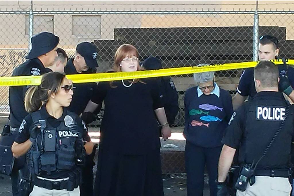 Eliana Scott-Thonnes (black dress) and another NACtivist protesting the mass eviction of homeless camps beneath the Spokane Street viaduct are arrested by SPD&rsquo;s Navigation Team on Friday, September 15, 2017. Photo by NACtivist Travis Thompson