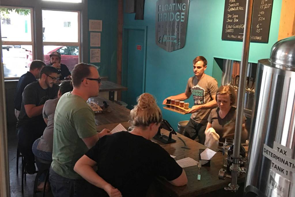 Dawn Perry and Russ Cornell work the tap room at Floating Bridge. Courtesy of Floating Bridge Brewing