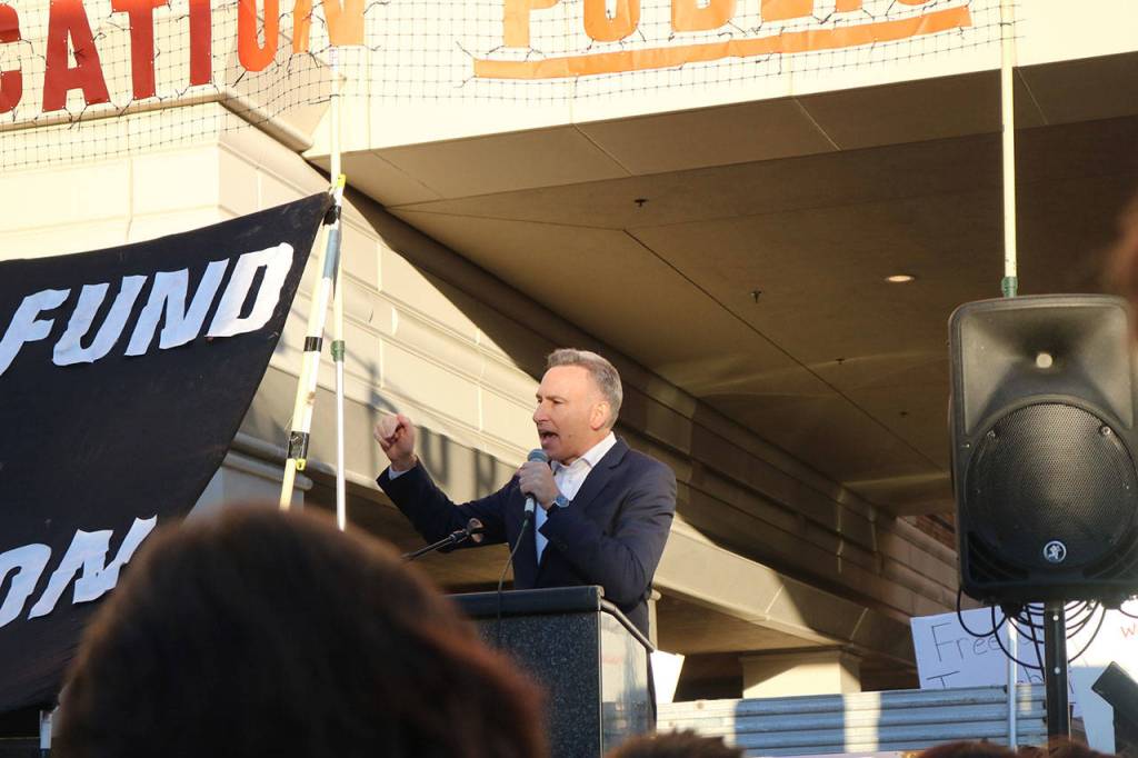 King County Executive Dow Constantine tells President Trump that he is failing the American people at the protest of U.S. Secretary of Education Betsy DeVos trip to Bellevue on Friday. Nicole Jennings/staff photo