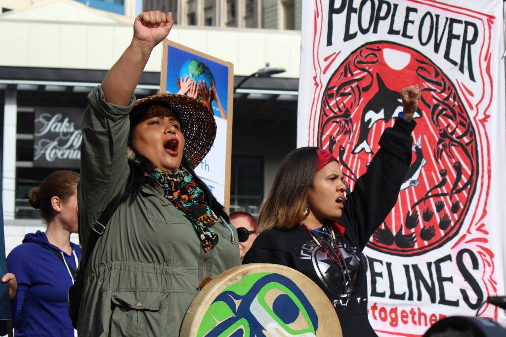 Indigenous activists Roxanne White and Rachel Heaton sing at Divest the Globe protest on October 23. Photos by Sara Bernard