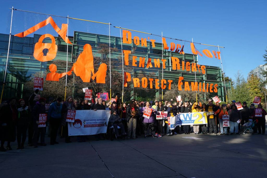 Advocates and politicians gather after a tenant rights rally outside of the Washington State Convention Center. Photo by Melissa Hellmann