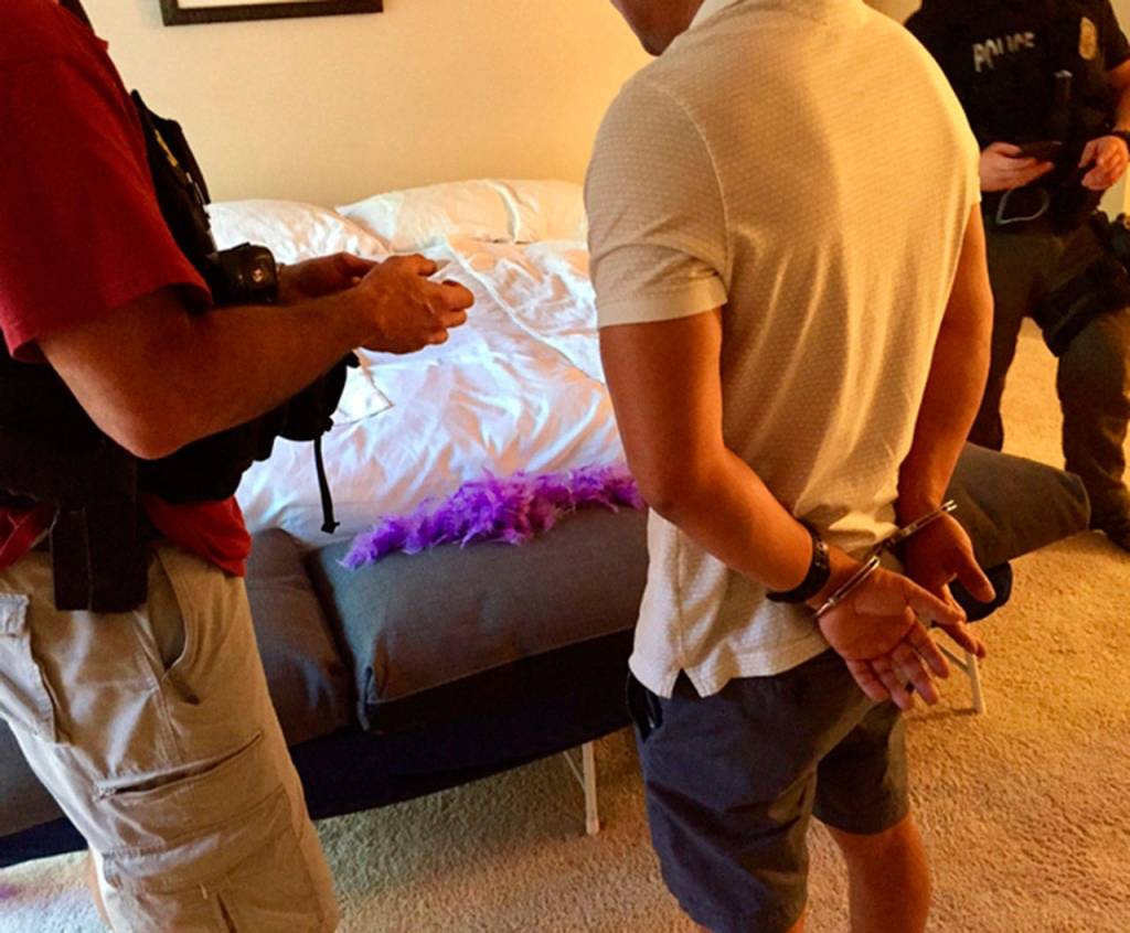 Police arrest a man at a Bellevue condo during the prostitution sting in August. Photo courtesy of the Bellevue Police Department