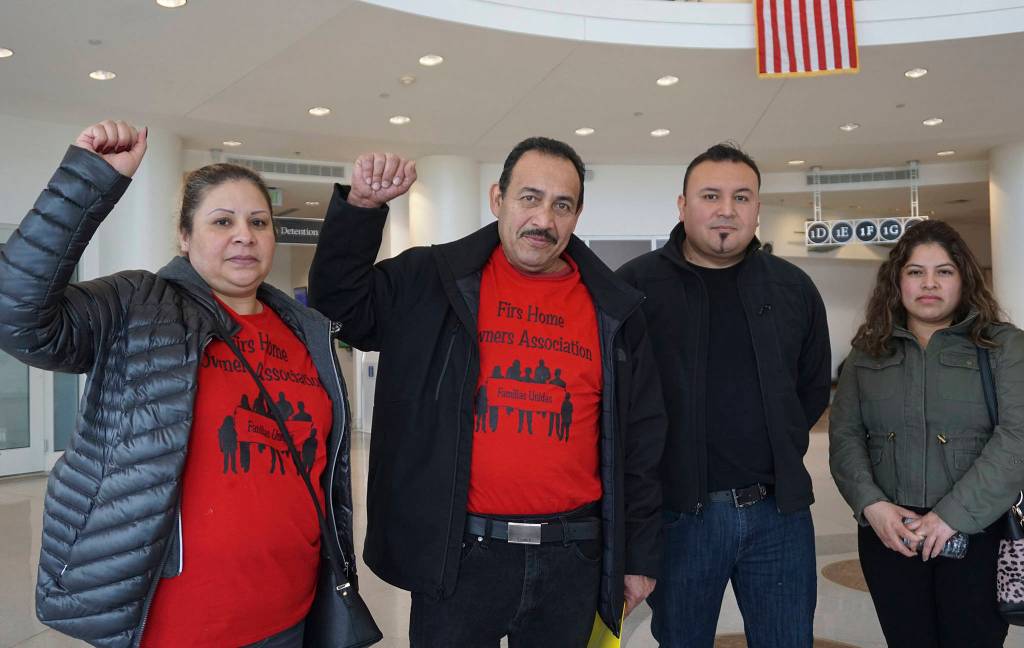 Firs Mobile Home Park residents stand in the King County Superior Court following a hearing on January 4. Photo by Melissa Hellmann