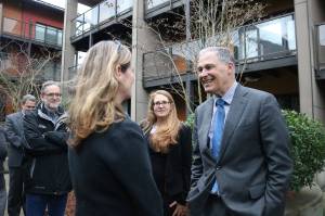 Photo by Nicole Jennings                                 Gov. Inslee greets new Issaquah Mayor Mary Lou Pauly outside the zHome housing development, the first zero-net-energy townhouse development in the United States.