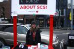 Mandy Sladky, a registered nurse, answers questions about safe consumption spaces at a public information booth outside of the Capitol Hill light rail station on February 7, 2018. Photo by Melissa Hellmann