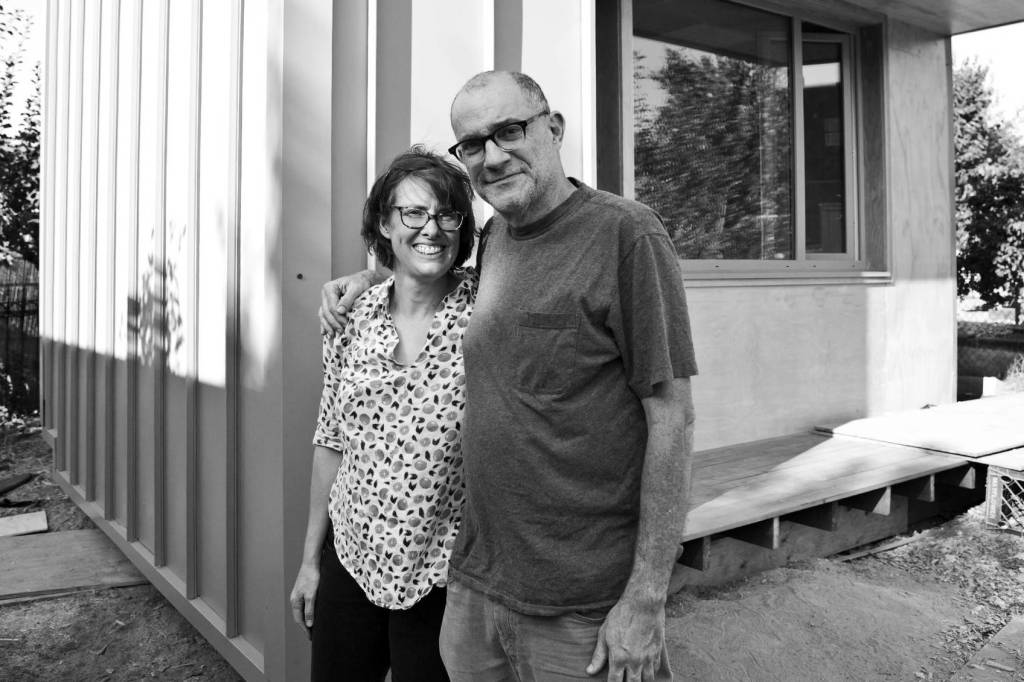 Hosts Kim Sherman and Dan Tenenbaum stand in front of the pilot BLOCK home in Beacon Hill. Photo courtesy Facing Homelessness