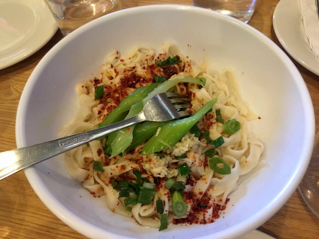 Jiaozi!s handmade noodles with red chili oil. Photo by Nicole Sprinkle