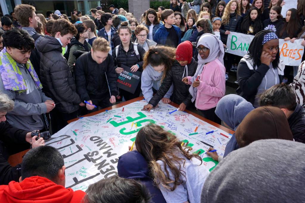 During the walkout, Garfield High School students sign a poster that will be delivered to politicians. Photo by Melissa Hellmann