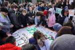 During the walkout, Garfield High School students sign a poster that will be delivered to politicians. Photo by Melissa Hellmann
