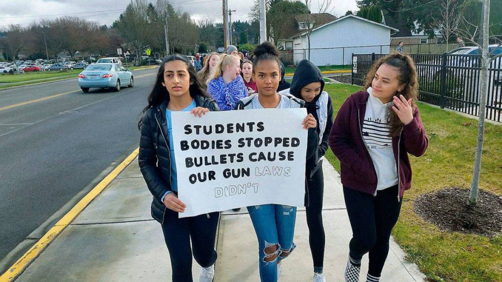 Japnoor Sandhu, top left, and Asia Bol, top right, freshman at Auburn Mountainview High School, joined Wednesdays nationwide student walkout and march they said, because they want schools to be what they should be: places to learn, not places to be shot. Photo by Robert Whale