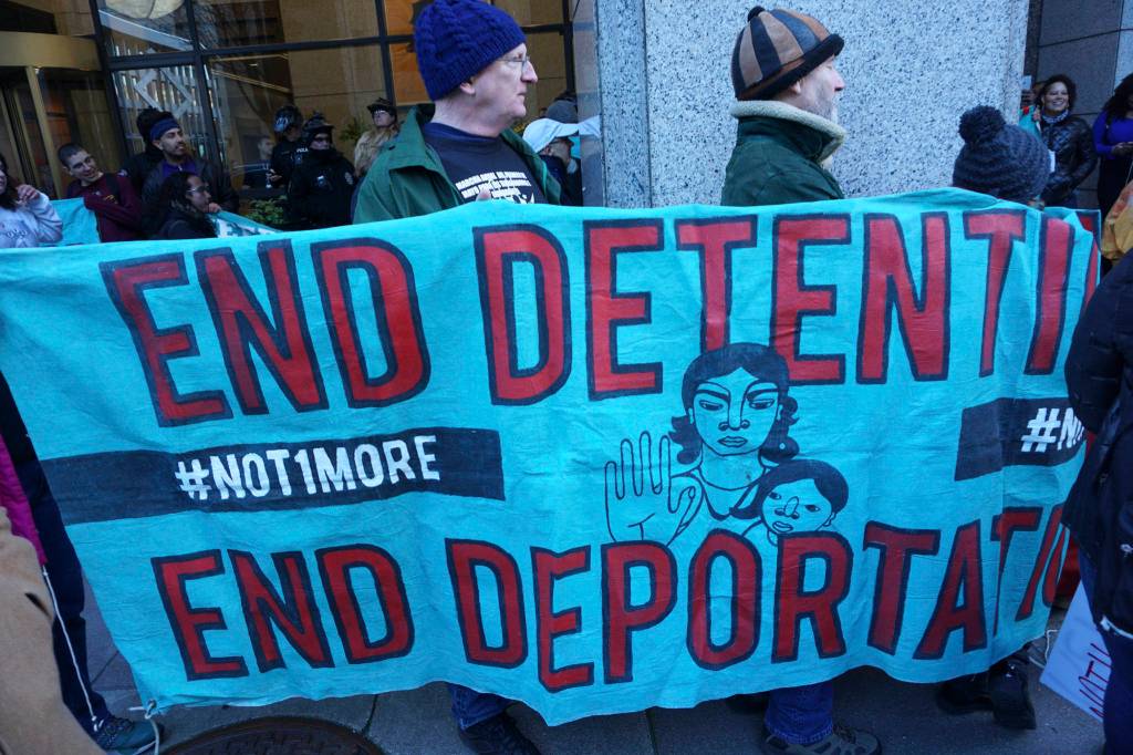 Protesters stand in solidarity with Maru Mora Villalpando during her first deportation hearing outside of the Seattle Immigration Court. Photo by Melissa Hellmann