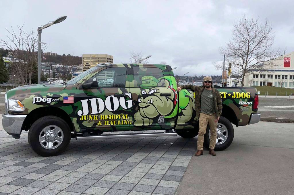 David Swaintek stands in front of his junk removal truck. Photo courtesy of Hanna Swaintek/JDog Junk Removal Lake Union