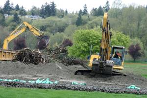Crews clear the way for development at Riverbends former par 3 golf course in Kent. Photo by Mark Klaas