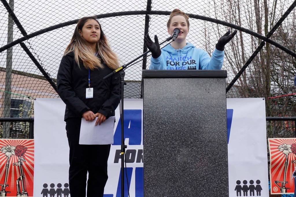 March for Our Lives Seattle founders Emilia Allard (right) and Rhiannon Rasaretnam (left) spoke at the rally on March 24, 2018. Photo by Melissa Hellmann