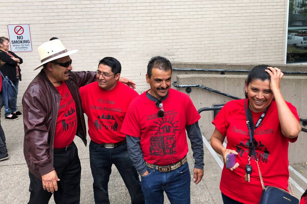 The Firs Homeowners Association celebrate outside of the Maleng Regional Justice Center after a ruling that buys them more time in their homes on June 7, 2018. Photo by Melissa Hellmann