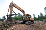 Pillons own excavator sits atop the hill overlooking his junkyard. It is one of the few functional vehicles on the property. Photo by Caean Couto