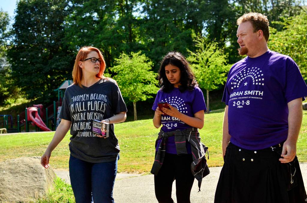 Sarah Smith walks with campaign volunteers Supreet Kaur and Fern Zimmerman 
to canvas apartments in the New Holly neighborhood in Southeast Seattle on July 7.                                 Photo by Josh Kelety