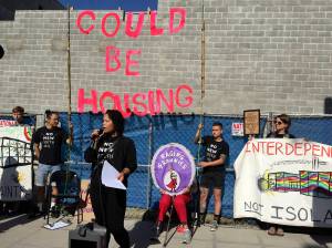 Nikkita Oliver speaks at a July 17 No New Youth Jail press conference in front of the construction site of the King County Youth Detention Center. Photo by Josh Kelety