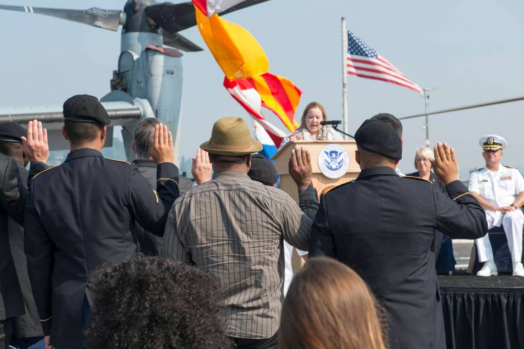 Soldiers and civilians at a naturalization ceremony during the 68th Annual Seafair Fleet Week in Seattle on Aug. 4, 2017. Flickr/U.S. Navy photo by Mass Communication Specialist 2nd Class Matthew Dickinson.