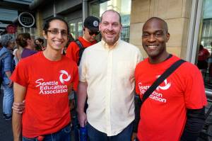 Greg DiGiacomo, Judson Kane, and Darryl James (left to right) attend a Seattle Education Association meeting at Benaroya Hall to vote for a strike authorization on Aug. 28, 2018. Photo by Melissa Hellmann
