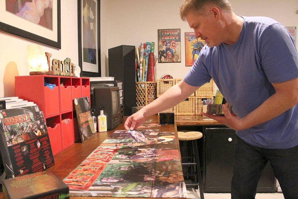 Greg McClellan of Kirkland assembles the complex album cover art puzzle for the first time. Madison Miller/staff photo.