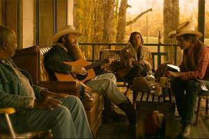 First-time actor Ben Dickey (with guitar) stars as the titular country songwriter Blaze Foley. Courtesy IFC Films